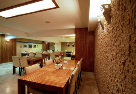 brick wall in dining area with tables and chairs