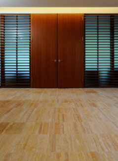 beige flooring with dark wood doors and windows