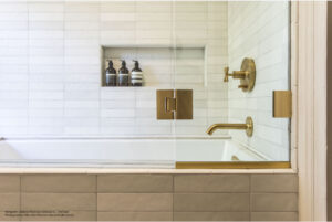 Bedrosian white tile tub with gold faucet