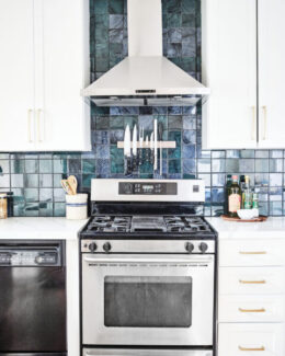 kitchen backsplash in blue square design with knives over stovetop