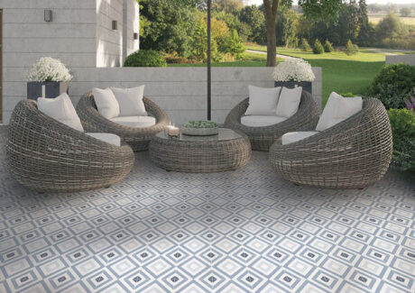 blue and white diamond tile flooring with rattan patio furniture in backyard