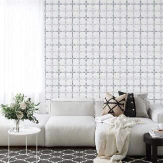 white sofa with blue and white tile on wall