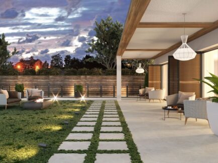 backyard patio with grass around square white tiles with patio cover