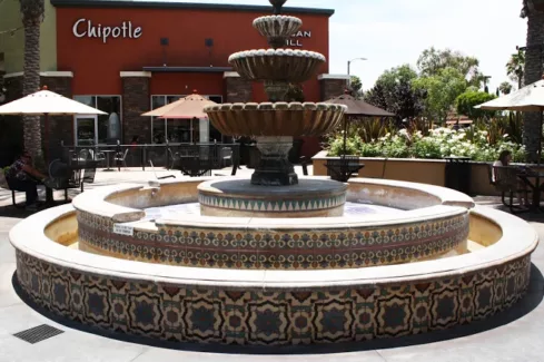 colorful tile fountain in front of a Chipotle store