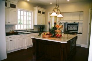 kitchen with white cabinets and dark wood flooring