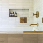 Bedrosian white tile tub with gold faucet