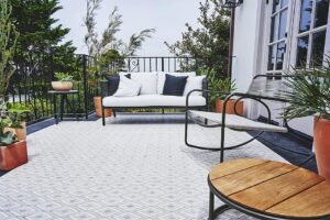 white and gray square tiles in diamond pattern with white patio sofa